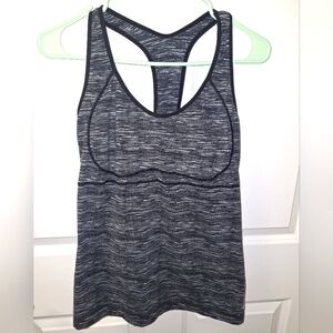 A Reebok ladies tank top in a size large with an open back. EUC. Black and grey.